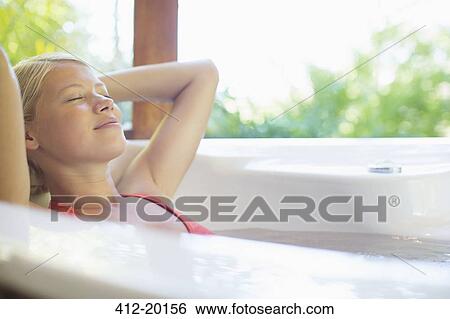 Woman relaxing in hot tub View Large Photo Image Stock Photograph - Woman relaxing in hot tub. Fotosearch