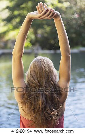 Woman stretching by pool View Large Photo Image Picture - Woman stretching by pool. Fotosearch