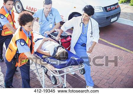Doctor, nurse and paramedics wheeling patient on stretcher View Large Photo Image Stock Photography - Doctor, nurse and paramedics wheeling patient on stretcher. Fotosearch