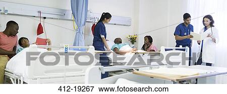 Stock Photo - Doctor, nurses and patients in hospital room. Fotosearch