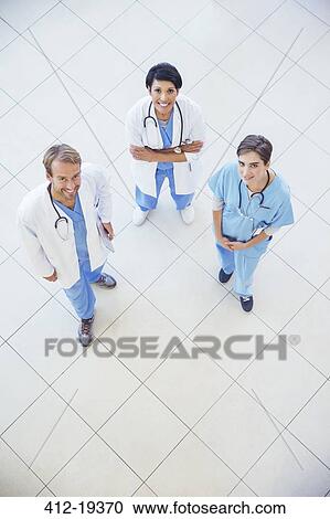 Doctors and nurse smiling in hospital View Large Photo Image Stock Image - Doctors and nurse smiling in hospital. Fotosearch