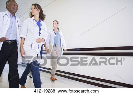 Stock Photo - Doctors and nurses in hospital hallway. Fotosearch