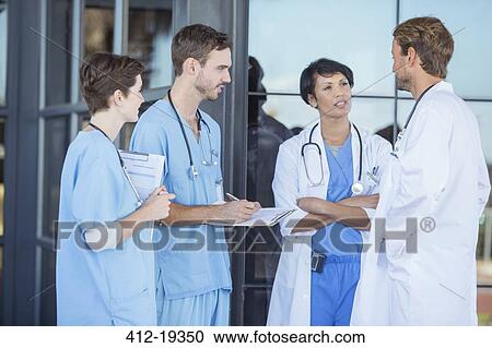 Doctors and nurses talking outside hospital View Large Photo Image Stock Image - Doctors and nurses talking outside hospital. Fotosearch