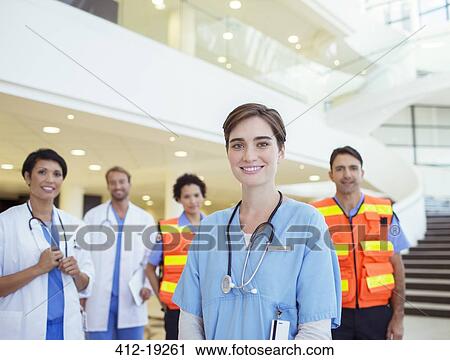 Stock Image - Doctors, nurses and paramedics smiling in hospital. Fotosearch