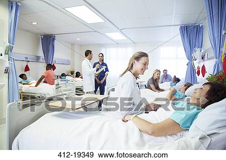Doctors, nurses and patients in hospital room View Large Photo Image Stock Photo - Doctors, nurses and patients in hospital room. Fotosearch