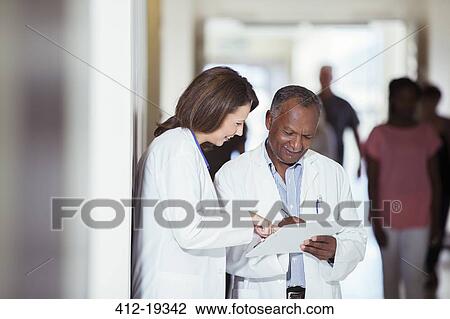 Doctors reading medical chart in hospital View Large Photo Image Stock Image - Doctors reading medical chart in hospital. Fotosearch