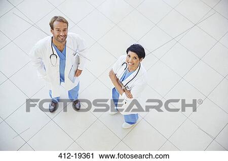 Stock Image - Doctors smiling in hospital. Fotosearch