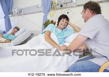 Man talking to wife in hospital View Large Photo Image Stock Photography - Man talking to wife in hospital. Fotosearch