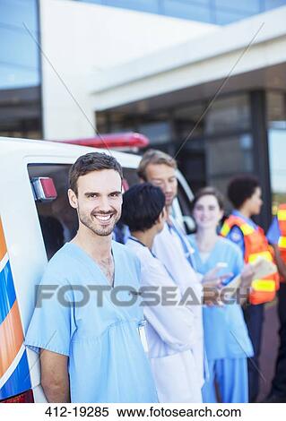 Nurse smiling by ambulance in hospital parking lot View Large Photo Image Stock Photography - Nurse smiling by ambulance in hospital parking lot. Fotosearch