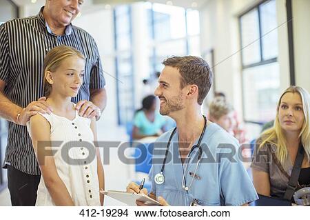 Picture - Nurse talking to patient in hospital. Fotosearch