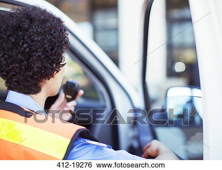 Paramedic using walkie talkie in ambulance View Large Photo Image Stock Photograph - Paramedic using walkie talkie in ambulance. Fotosearch