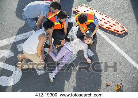 Paramedics examining injured girl on street View Large Photo Image Stock Image - Paramedics examining injured girl on street. Fotosearch