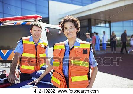 Paramedics smiling by ambulance in hospital parking lot View Large Photo Image Stock Image - Paramedics smiling by ambulance in hospital parking lot. Fotosearch