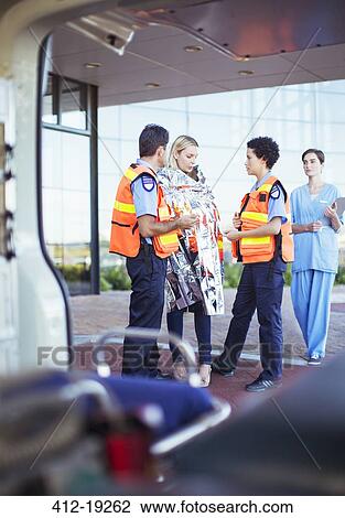 Paramedics talking to patient in hospital parking lot View Large Photo Image Stock Image - Paramedics talking to patient in hospital parking lot. Fotosearch