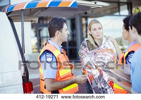 Paramedics talking to patient in hospital parking lot View Large Photo Image Stock Image - Paramedics talking to patient in hospital parking lot. Fotosearch