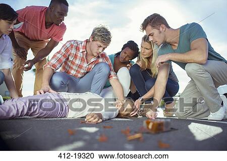 Stock Image - People rushing to injured girl on street. Fotosearch