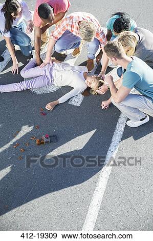 People rushing to injured girl on street View Large Photo Image Stock Photo - People rushing to injured girl on street. Fotosearch