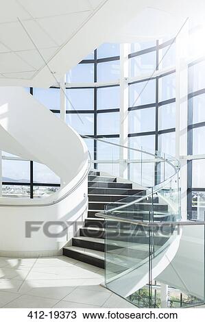 Spiral staircase in modern building View Large Photo Image Stock Image - Spiral staircase in modern building. Fotosearch