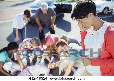 Picture - Woman calling emergency services at car accident. Fotosearch