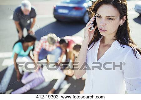 Woman calling emergency services at car accident View Large Photo Image Stock Image - Woman calling emergency services at car accident. Fotosearch