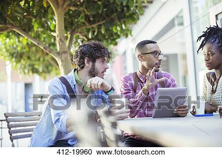 Friends talking at sidewalk cafe View Large Photo Image Stock Image - Friends talking at sidewalk cafe. Fotosearch