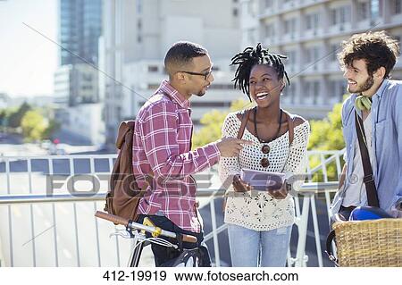 Stock Photo - Friends talking on city street. Fotosearch