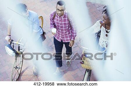 Stock Photo - Friends walking on city street. Fotosearch