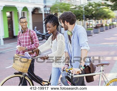 Stock Photo - Friends walking together on city street. Fotosearch