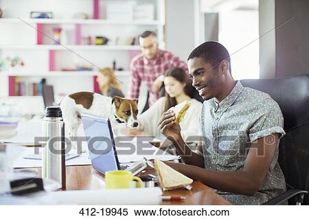 Man eating at conference table in office View Large Photo Image Stock Photography - Man eating at conference table in office. Fotosearch