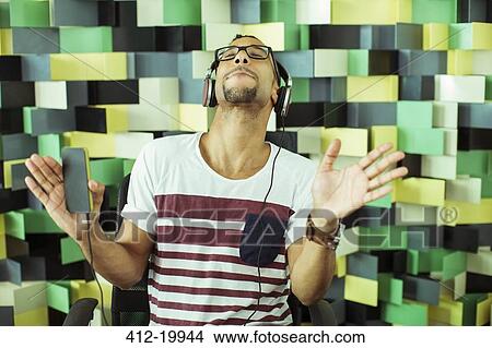 Man listening to headphones View Large Photo Image Picture - Man listening to headphones. Fotosearch