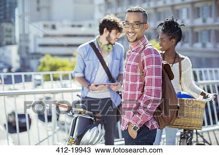 Stock Image - Man smiling on city street. Fotosearch