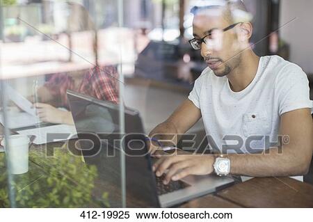 Man using laptop in cafe View Large Photo Image Stock Photography - Man using laptop in cafe. Fotosearch