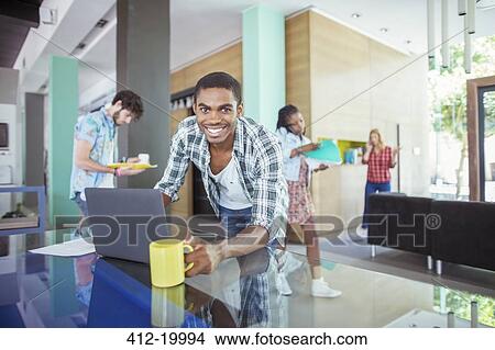 Picture - Man working at conference table in office. Fotosearch