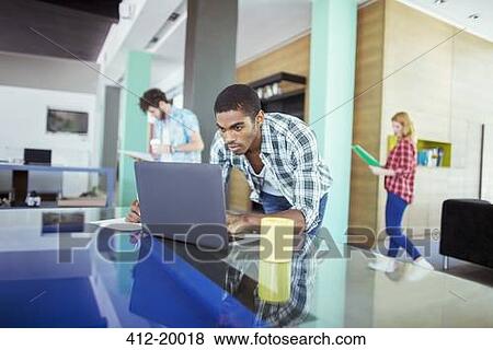 Man working on laptop in office View Large Photo Image Stock Photo - Man working on laptop in office. Fotosearch