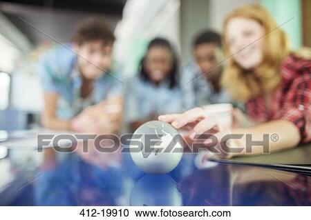 People examining miniature globe View Large Photo Image Stock Image - People examining miniature globe. Fotosearch