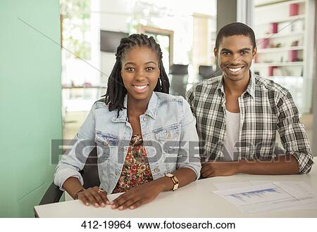 Picture - People smiling together in office. Fotosearch