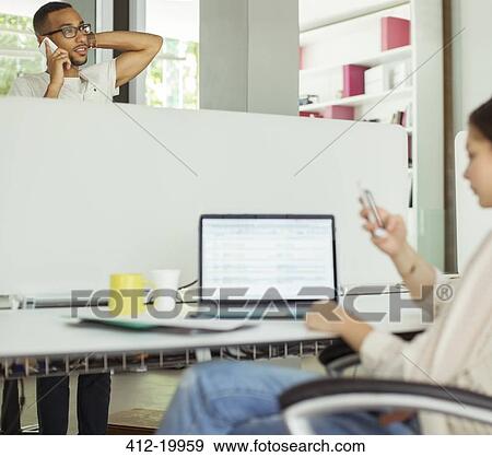 People using cell phones in office View Large Photo Image Stock Photo - People using cell phones in office. Fotosearch