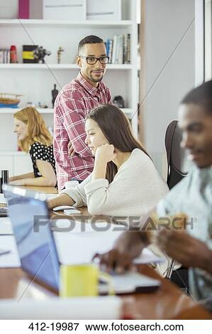 People working at conference table in office View Large Photo Image Stock Photo - People working at conference table in office. Fotosearch