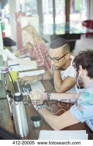 Stock Photography - People working together at conference table in office. Fotosearch