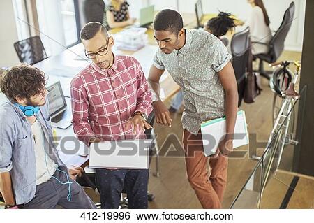Stock Photograph - People working together in office. Fotosearch