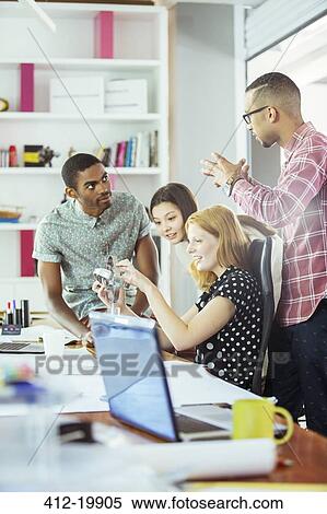 Stock Photography - People working together in office. Fotosearch