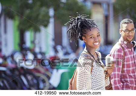Woman drinking coffee on city street View Large Photo Image Stock Image - Woman drinking coffee on city street. Fotosearch