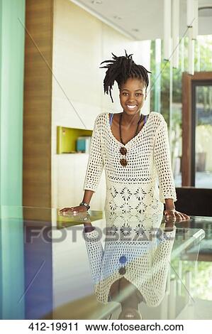 Stock Image - Woman smiling in office. Fotosearch