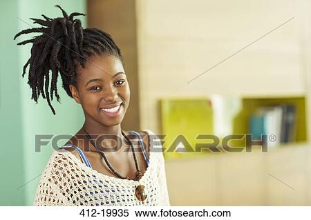 Stock Photography - Woman smiling in office. Fotosearch