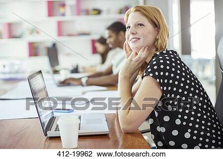 Woman working at conference table in office View Large Photo Image Stock Image - Woman working at conference table in office. Fotosearch