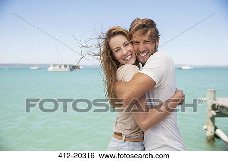 Couple hugging near water View Large Photo Image Stock Photograph - Couple hugging near water . Fotosearch