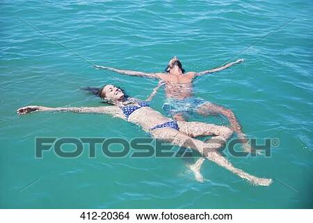Picture - Couple relaxing in water together. Fotosearch