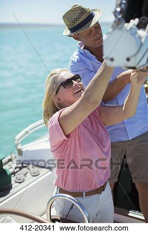 Couple sailing boat together View Large Photo Image Stock Image - Couple sailing boat together. Fotosearch