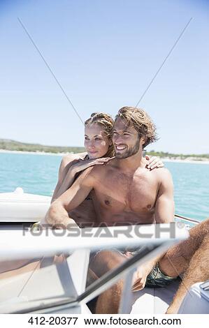 Couple sitting in boat on water View Large Photo Image Stock Photo - Couple sitting in boat on water. Fotosearch