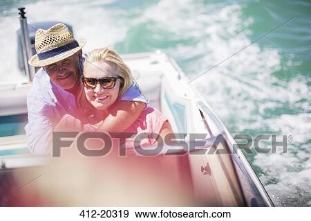 Stock Photo - Couple sitting in boat together . Fotosearch
